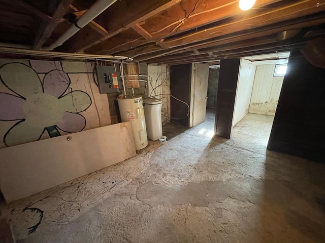 basement featuring electric water heater and electric panel