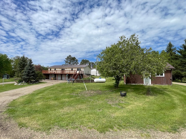 view of front facade featuring a wooden deck and a front yard