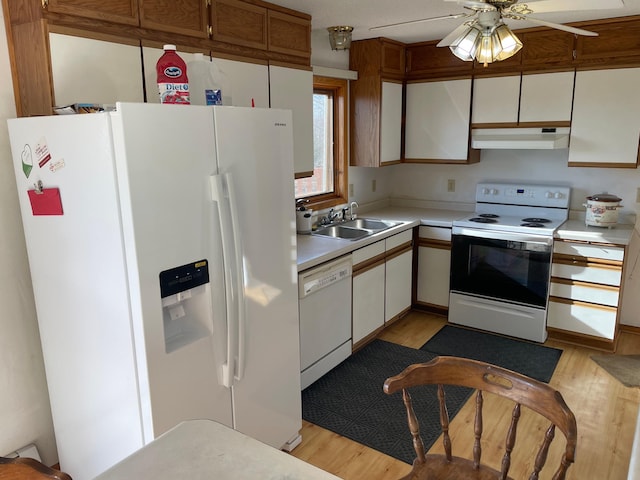 kitchen featuring white cabinetry, light wood-type flooring, white appliances, and sink