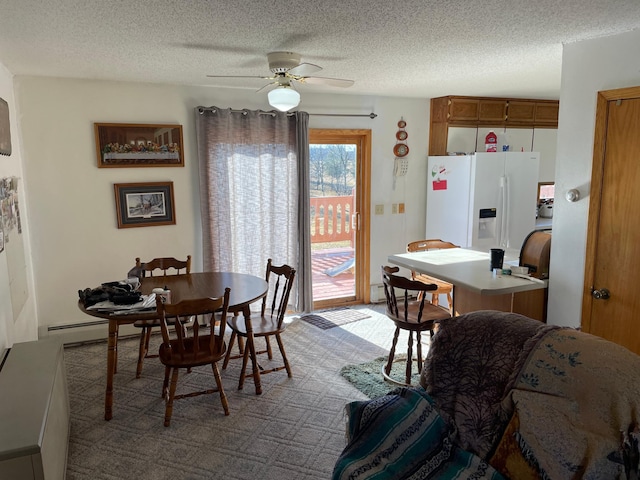 dining room featuring ceiling fan and a textured ceiling