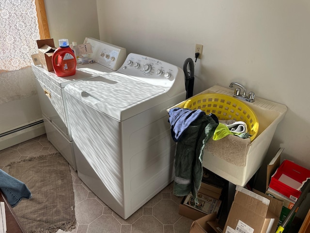 clothes washing area featuring washer and dryer, light tile patterned floors, and a baseboard heating unit