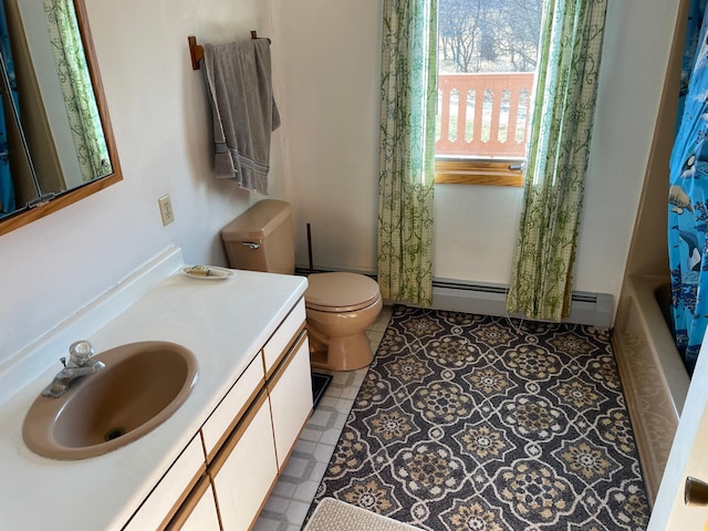 full bathroom featuring shower / tub combo with curtain, vanity, a baseboard heating unit, and toilet