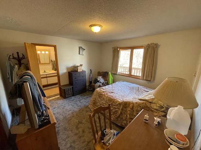 bedroom with connected bathroom, carpet floors, and a textured ceiling