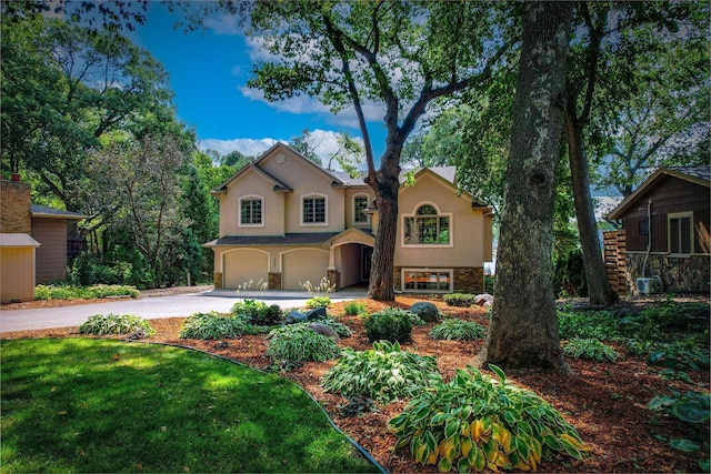 view of front of property with a garage and a front lawn