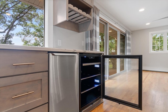 kitchen featuring beverage cooler and light wood-type flooring