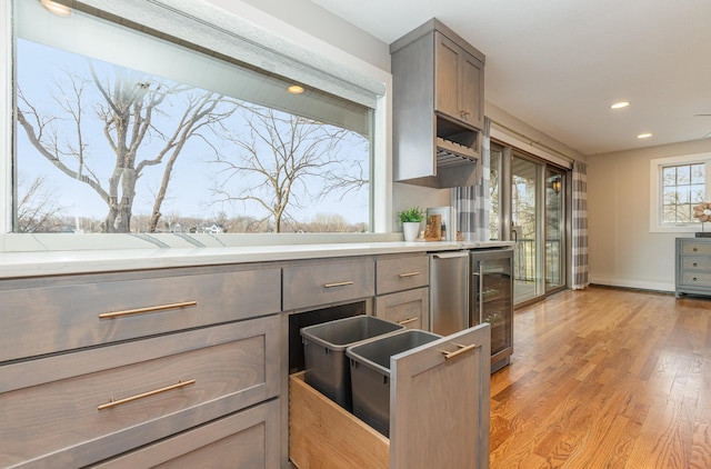 kitchen featuring wine cooler and light wood-type flooring