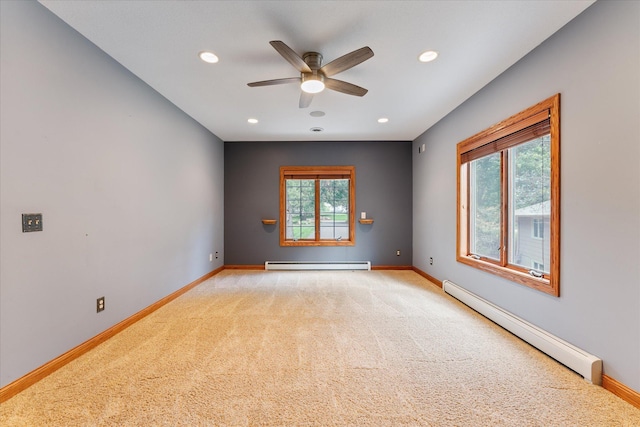 empty room with light carpet, a baseboard radiator, and ceiling fan