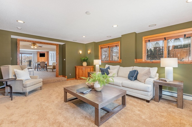 living room featuring light carpet and a baseboard heating unit