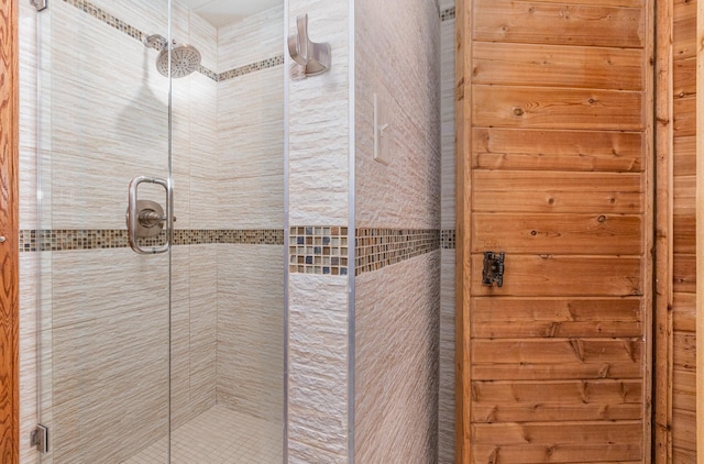 bathroom featuring a shower with shower door