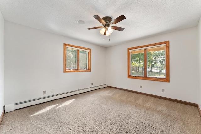 spare room featuring ceiling fan, a baseboard radiator, light colored carpet, and a textured ceiling