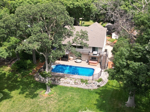 view of swimming pool with a lawn, a patio area, and a jacuzzi