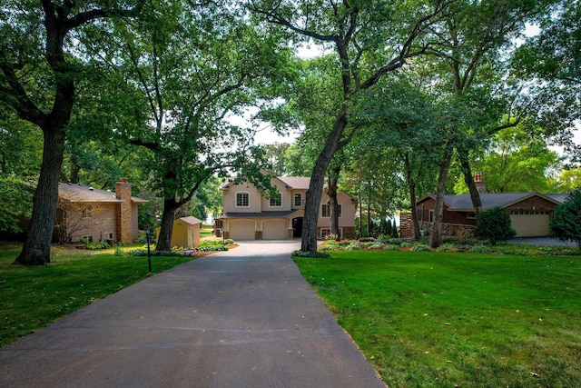 view of front of property with a garage and a front yard