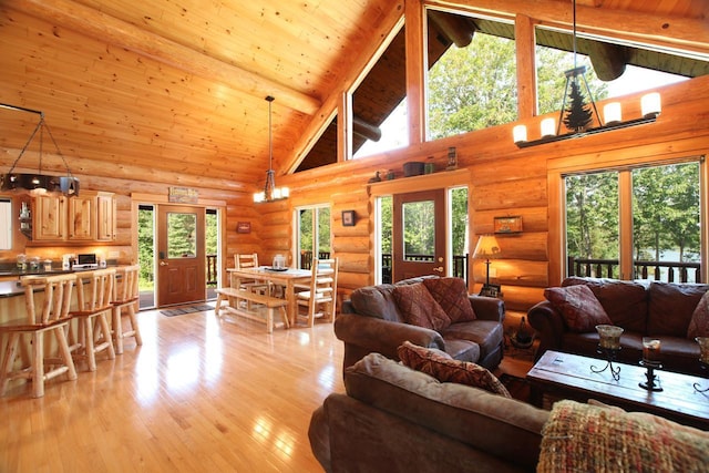 living room featuring high vaulted ceiling, wood ceiling, beam ceiling, light hardwood / wood-style flooring, and rustic walls