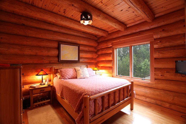 bedroom with beamed ceiling, wooden ceiling, light hardwood / wood-style floors, and log walls