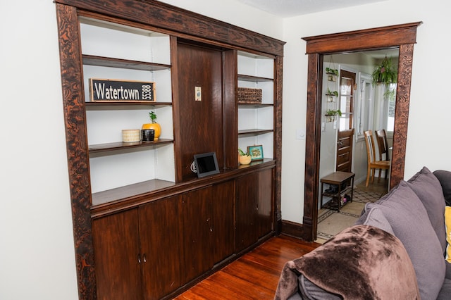 interior space featuring dark hardwood / wood-style flooring and dark brown cabinets