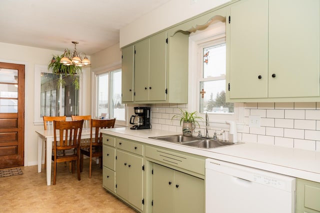 kitchen featuring sink, hanging light fixtures, dishwasher, and green cabinets