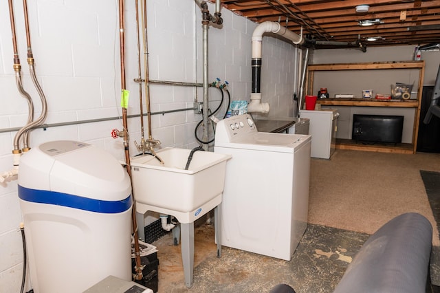 clothes washing area with washing machine and clothes dryer and sink