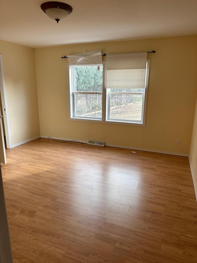 spare room with light wood-type flooring