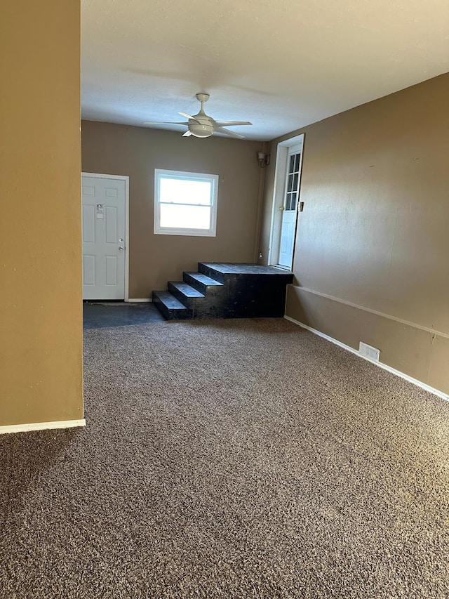 carpeted empty room featuring ceiling fan