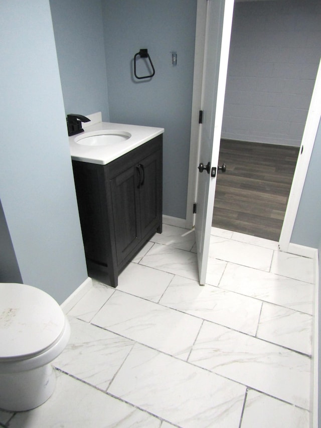 bathroom featuring vanity, hardwood / wood-style floors, and toilet