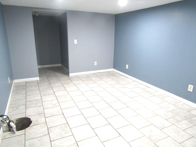 spare room featuring light tile patterned flooring