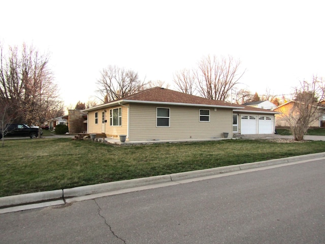 view of home's exterior featuring a yard and a garage