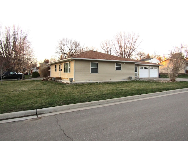 214 12th St, Montevideo, MN 56265 - view of home's exterior featuring driveway, a garage, and a lawn