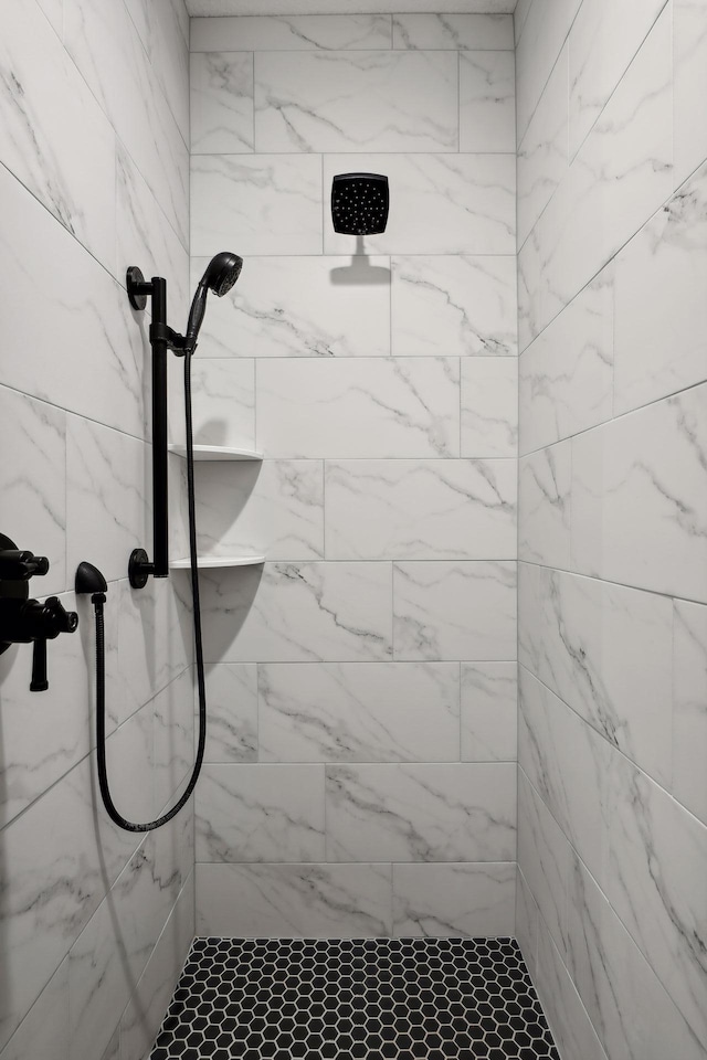 bathroom with a tile shower