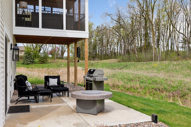 view of patio / terrace featuring a grill and a sunroom