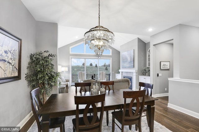 dining room featuring an inviting chandelier, lofted ceiling, and dark hardwood / wood-style floors