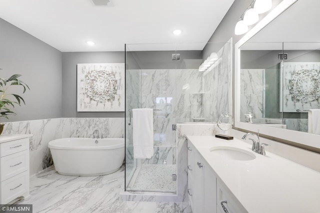 bathroom featuring tile walls, vanity, and shower with separate bathtub