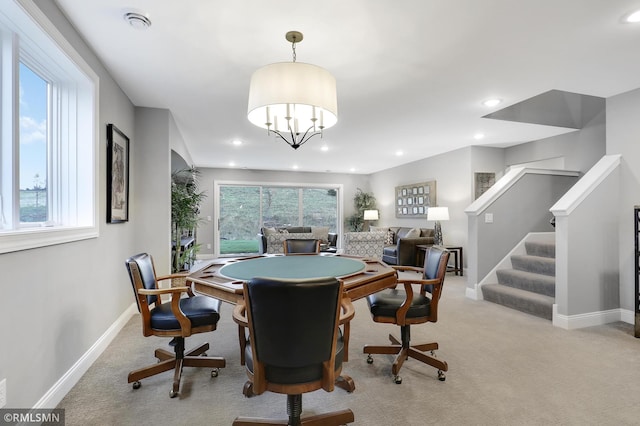 rec room featuring light carpet and a notable chandelier