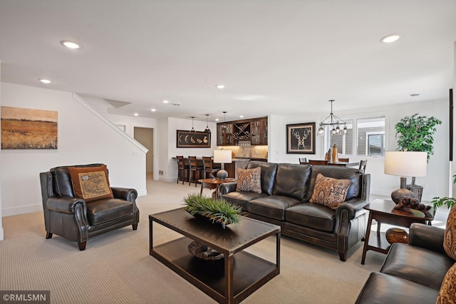 living room featuring light colored carpet, bar area, and a chandelier