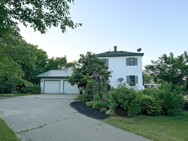 view of front of house featuring an outdoor structure and a garage