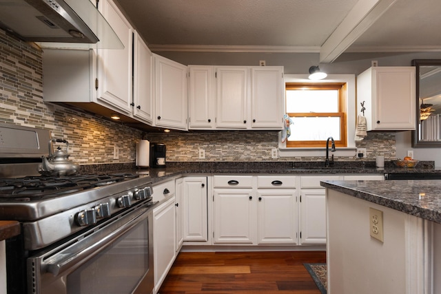 kitchen featuring backsplash, ventilation hood, dark stone countertops, gas stove, and white cabinetry