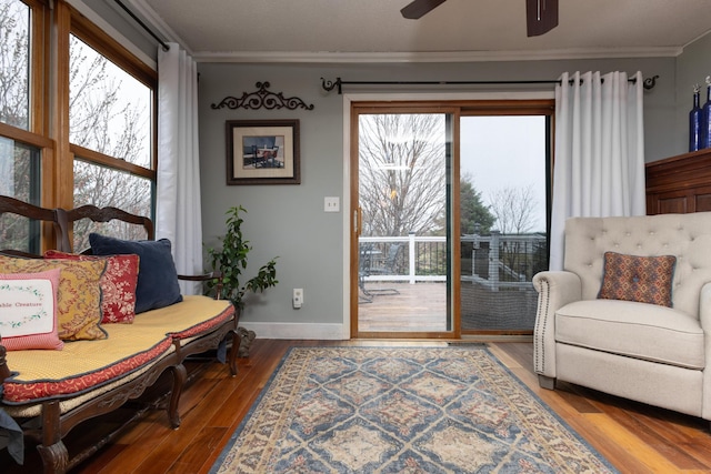 sitting room with hardwood / wood-style floors, ceiling fan, a healthy amount of sunlight, and ornamental molding