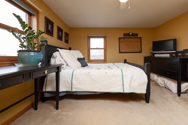 bedroom with light carpet and ceiling fan