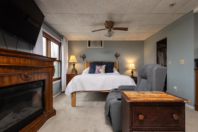 bedroom featuring carpet flooring, ceiling fan, a closet, and a spacious closet