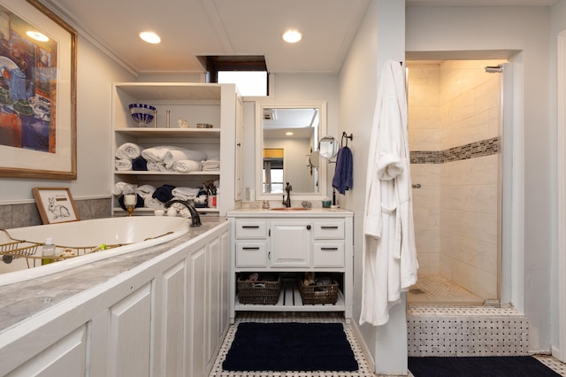 bathroom featuring a tile shower and vanity