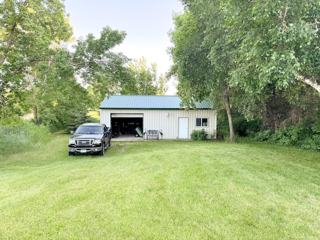 view of outbuilding featuring a yard and a garage