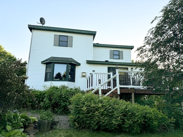 rear view of house featuring a deck