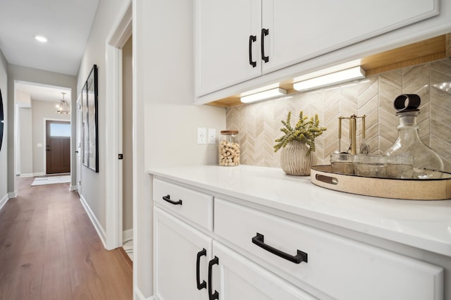 interior space with hardwood / wood-style flooring and white cabinets