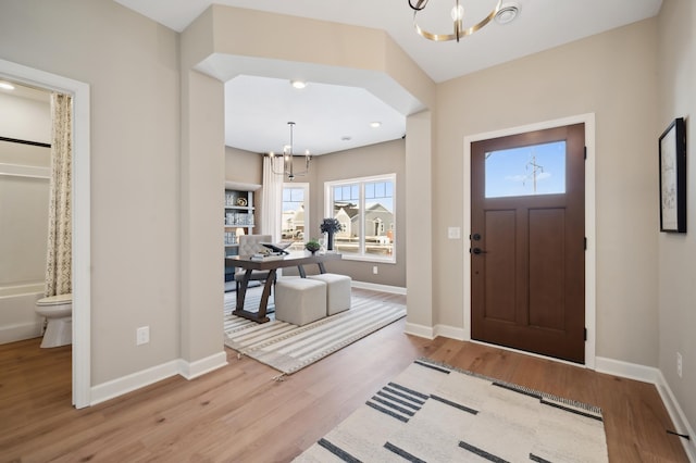 foyer featuring light hardwood / wood-style flooring and a notable chandelier