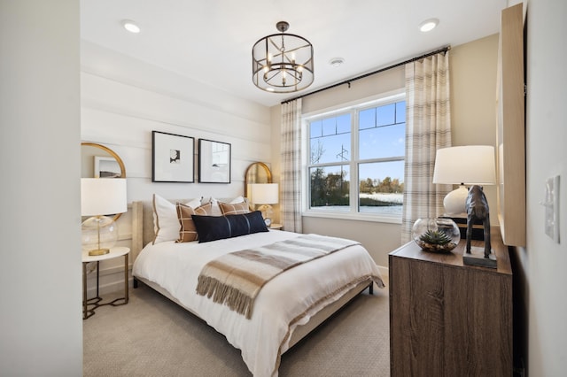 carpeted bedroom featuring a chandelier