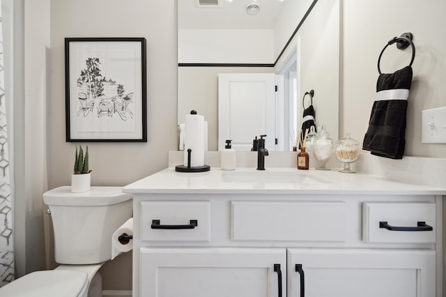 bathroom with toilet and vanity