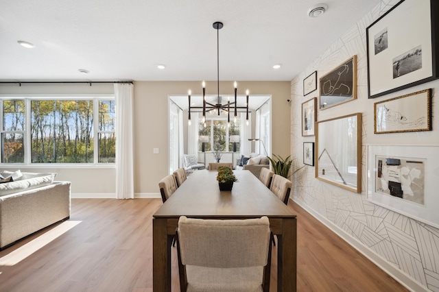 dining space featuring an inviting chandelier and light hardwood / wood-style floors