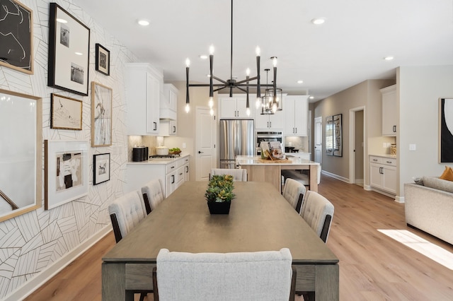 dining space featuring a chandelier and light hardwood / wood-style floors