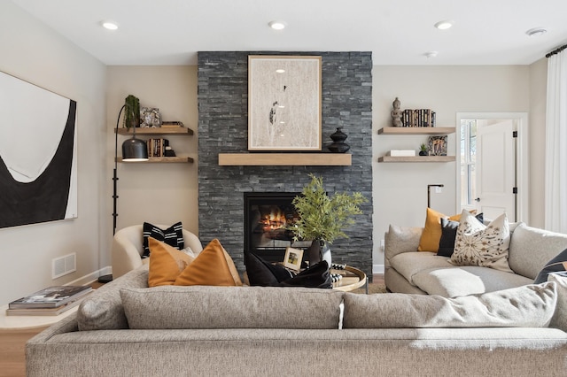 living room with a fireplace and hardwood / wood-style flooring