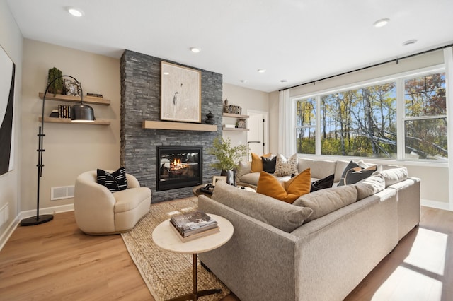 living room featuring light hardwood / wood-style flooring and a fireplace