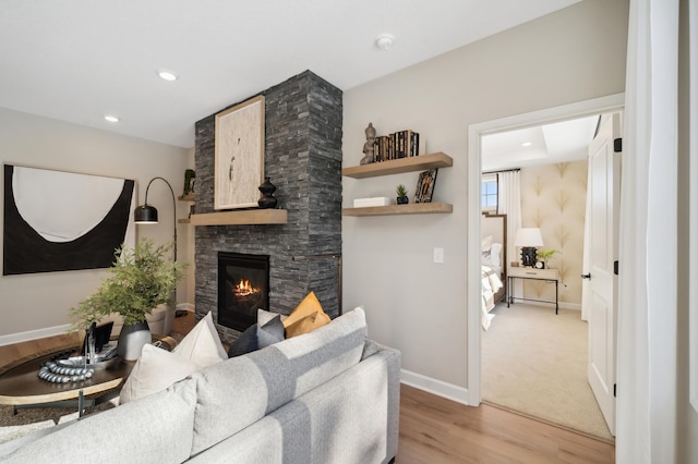 carpeted living room featuring a fireplace